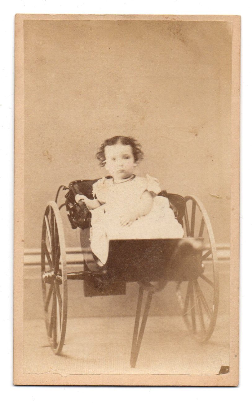 Carte de visite photo of baby girl in two-wheel cart