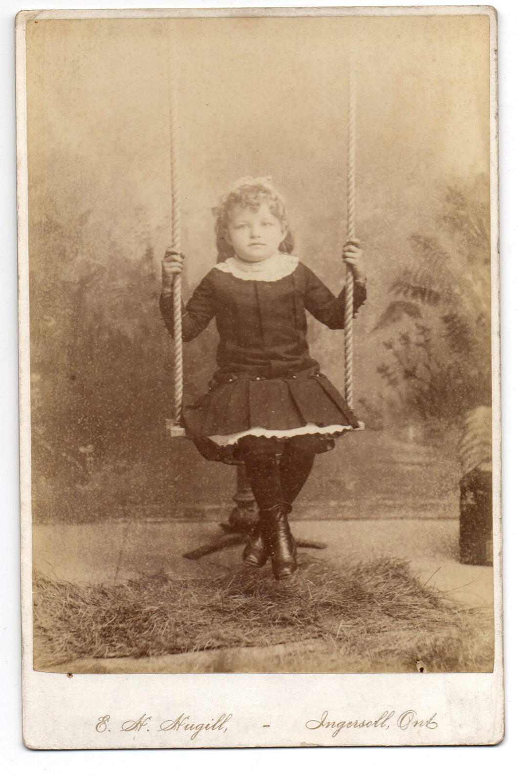 Photo of unidentified little girl on swing
